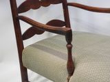 a wooden chair with a green cushion on it