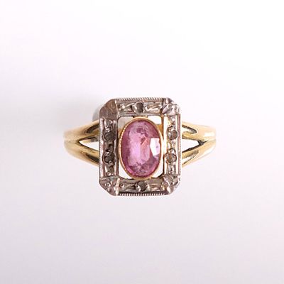 an image of a ring with a pink stone in it