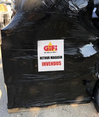 a pile of black garbage bags sitting on a pallet