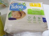 a bag of diapers sitting on a counter next to a bottle of milk