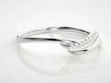 a close up of a diamond ring on a white surface