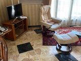 a living room with a chair and a television in it