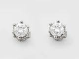 a pair of diamond earrings on a white background