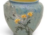 a blue vase with yellow flowers painted on it