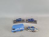 three toy trucks that are next to each other on a table