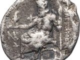 a silver coin with a woman sitting on top of it
