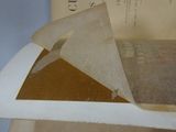 a piece of paper on top of a book on a table