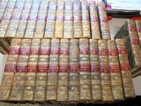 a lot of old books stacked on top of each other