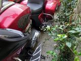many motorcycles parked next to each other on the side of the road