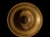 a close up view of a metal object on a black background