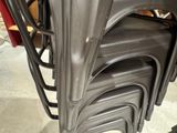 a lot of chairs that are stacked on top of each other