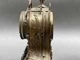 two antique clocks sitting next to each other on a table