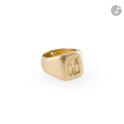 a close up of a gold signet ring on a white background