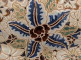 a close up of a decorative plate with a flower design