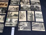 many old black and white photographs on display on a table