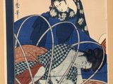 an image of a woman in a blue kimono sitting on a bed next to a cat