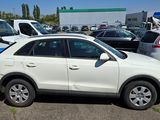 a white car parked in a parking lot next to other cars