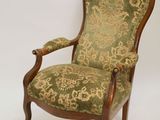 an image of a green and gold chair with a foot stool
