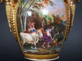 a vase with a painting on it that has animals on it