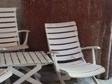 two lawn chairs sitting next to each other in a room