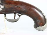 an old gun with a wooden handle on a white surface