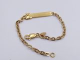 a close up of a gold chain bracelet on a white surface