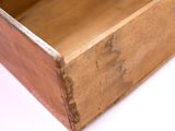 a wooden box with a handle on a white surface