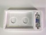 a pill case with two pills in it on a white surface