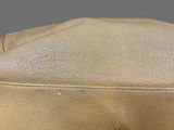 the inside of a tan leather purse with a zipper on it