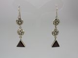 a pair of silver earrings with red glass beads on them