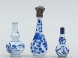 three blue and white vases are sitting next to each other on a white surface