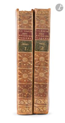 two old books sitting on top of each other on a white surface