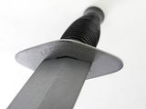 a close up of a knife on a white surface