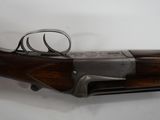 a close up of a rifle on a white surface