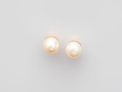 a pair of pearl earrings on a white background