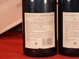 two bottles of wine sitting next to each other on a table