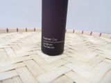 a bottle of liquid sitting on top of a woven basket