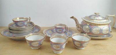 a tea set on a table with cups and saucers