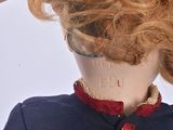 a mannequin head with red hair and a red bow tie