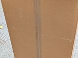 a cardboard box that is sitting on the ground