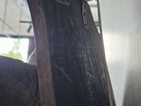 a close up of a person ' s hand holding a piece of wood