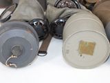 many different types of gas masks sitting on a table