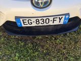 a white car that is parked in the grass