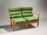 two chairs with green cushions on them on a gray background