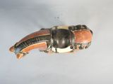 a brown and black elephant figurine on a white surface