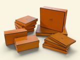 six orange boxes are stacked on top of each other on a white surface