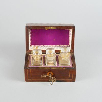 a small wooden box with a glass set inside of it