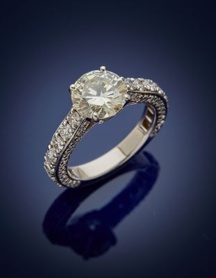 an engagement ring with a round brilliant cut diamond set in 18k white gold