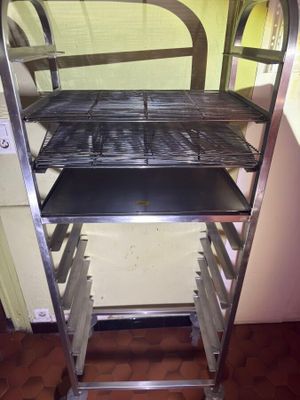 a metal rack with trays on it in a kitchen