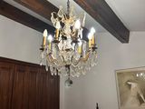 a chandelier hanging from the ceiling in a bedroom